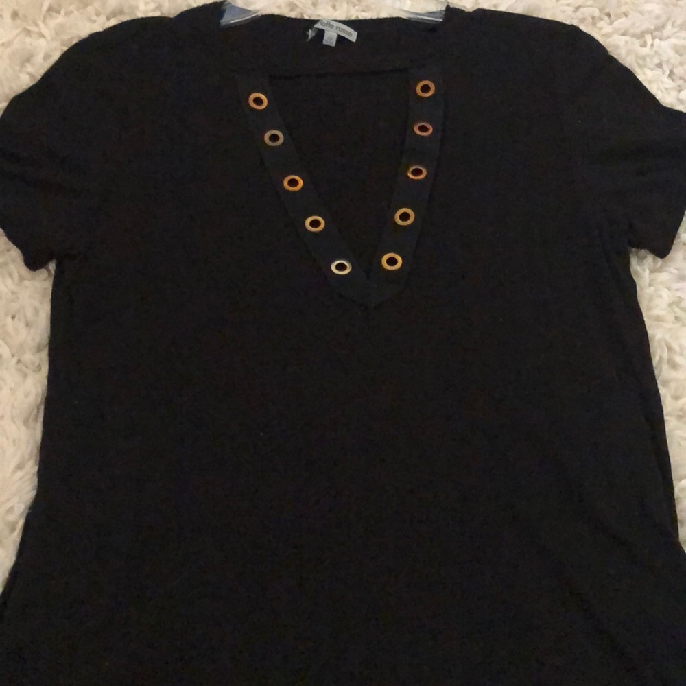 Black tee with gold rings on the plunge neckline